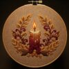 close-up-cross-stitched-picture-lit-candle