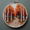 close-up-cross-stitched-picture-road-woods