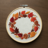 close-up-embroidery-wreath-leaves-berries