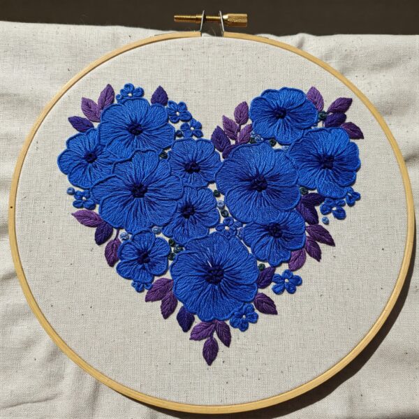 close-up-blue-heart-made-flowers-white-cloth