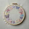embroidery-circle-butterflies-pearls-white-cloth