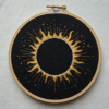 close-up-black-gold-embroidery-sun-middle