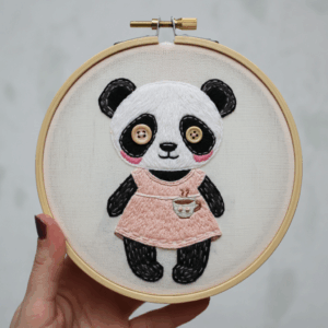 close-up-person-holding-embroidery-panda-bear