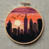 close-up-embroidery-city-birds-flying-sky