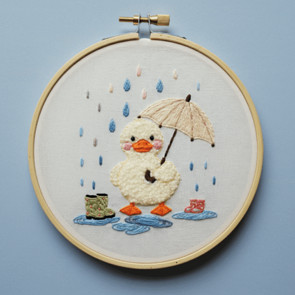 close-up-cross-stitched-picture-duck-umbrella