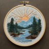 close-up-cross-stitched-picture-mountain-scene