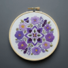 close-up-cross-stitched-picture-purple-flowers