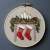 close-up-cross-stitched-picture-stockings-candles
