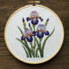 close-up-embroidery-purple-irises-wooden-surface