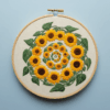 close-up-embroidery-sunflowers-blue-surface