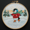 close-up-embroideryed-penguin-wearing-scarf-hat