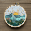 close-up-embroideryed-picture-mountain-sun