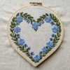 heart-shaped-embroidery-blue-flowers-white-cloth
