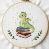 arafed-dragon-sitting-stack-books-white-surface