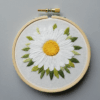 close-up-white-flower-embroidered-wooden-hoop