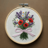 embroidery-bouquet-flowers-ribbon-brown-surface