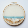embroidery-seashell-white-background-blue-ocean