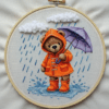 embroidery-teddy-bear-raincoat-holding-umbrella