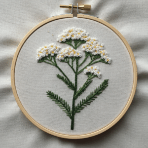 embroidery-white-flower-green-leaves-white-cloth