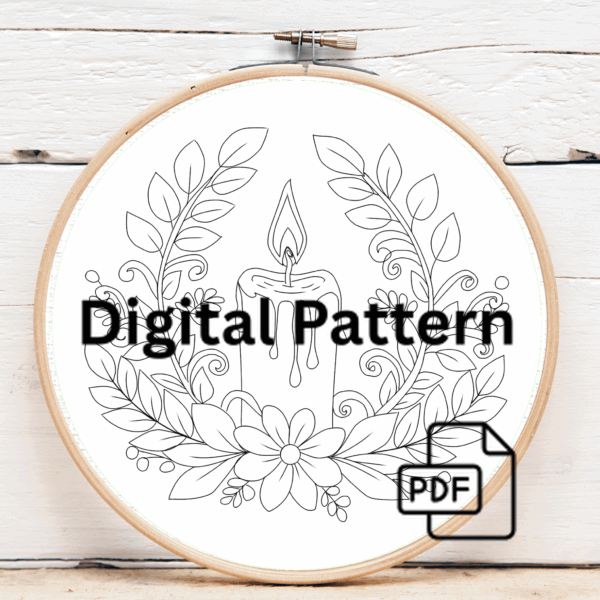 close-up-cross-stitched-picture-lit-candle