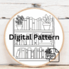 close-up-cross-stitched-picture-shelf-books-plants