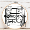 close-up-cross-stitched-picture-window-cup-coffee