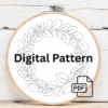 close-up-embroideryed-wreath-leaves-brown-surface