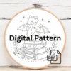 cross-stitch-dragon-sitting-top-stack-books