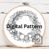 embroidery-wreath-flowers-leaves-linen-surface