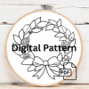 close-up-cross-stitch-wreath-pine-cones-red-ribbon